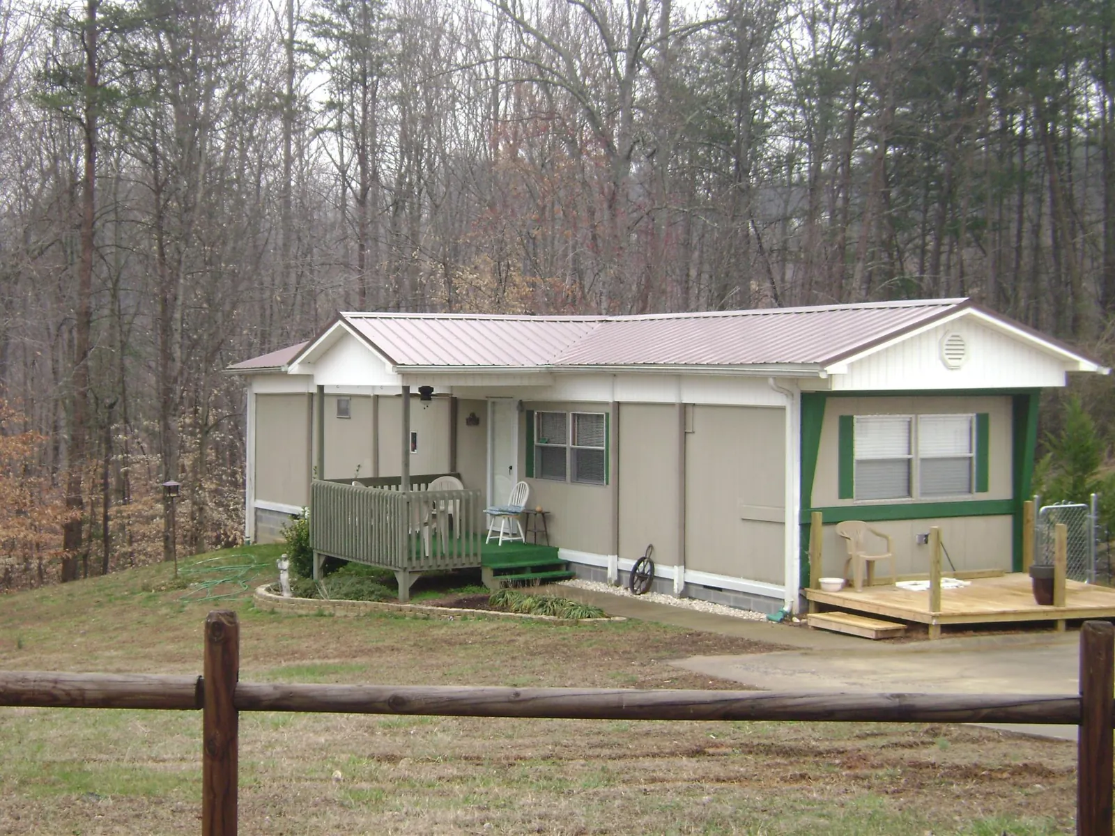 Mauve metal roof on a manufactured home with a new front deck in Pond Creek